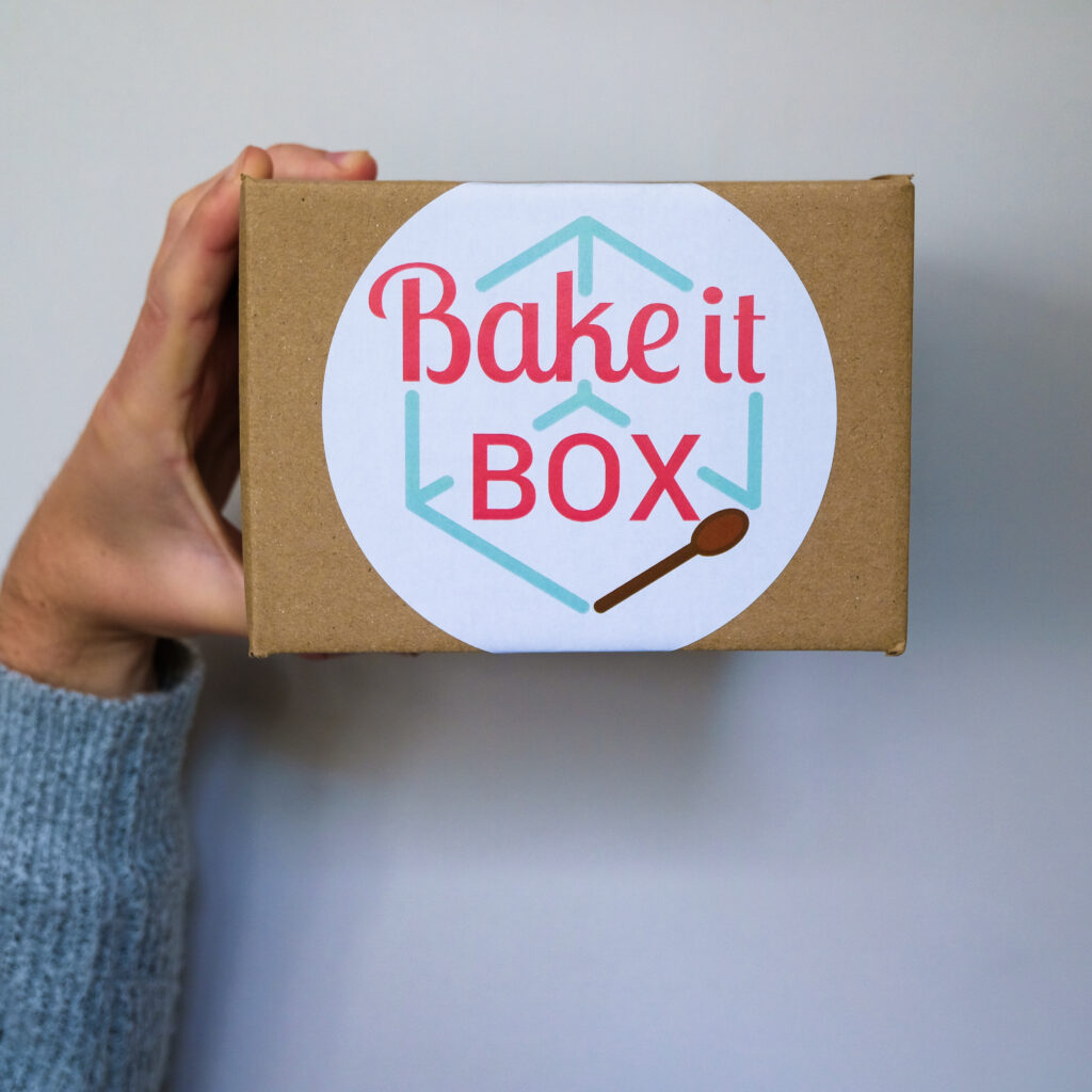 Holding branded bake it box in the air